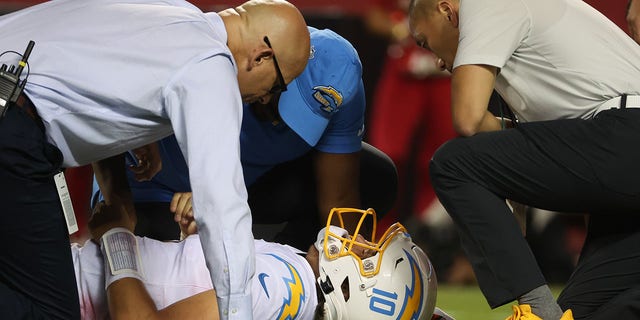 Los Angeles Chargers quarterback Justin Herbert (10) lies on the field after a hard hit in the fourth quarter against the Kansas City Chiefs Sept. 15, 2022, at GEHA Field at Arrowhead Stadium in Kansas City, Mo. 