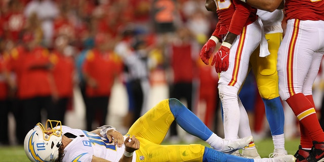 Justin Herbert of the Los Angeles Chargers after being hit during the Chiefs game at Arrowhead Stadium on Sept. 15, 2022, in Kansas City, Missouri.