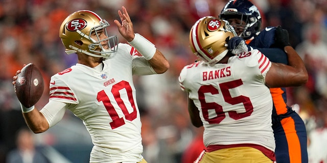 San Francisco 49ers quarterback Jimmy Garoppolo (10) passes against the Denver Broncos during the first half of an NFL football game in Denver, Sunday, Sept. 25, 2022.