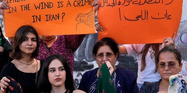 Kurdish women activists hold up placards during a protest against the death of Iranian Mahsa Amini in Iran, at Martyrs' Square in downtown Beirut, Lebanon, Wednesday, Sept. 21, 2022. 