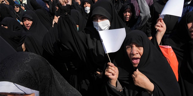 Iranian pro-government demonstrators attend a rally after their Friday prayers to condemn recent anti-government protests over the death of a young woman in police custody, in Tehran, Iran, Friday, Sept. 23, 2022. 