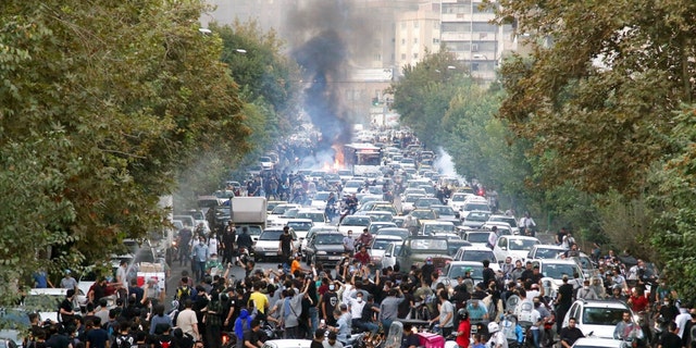 In this photo taken by an individual not employed by the Associated Press and obtained by the AP outside Iran, protesters chant slogans during a protest over the death of a woman who was detained by the morality police, in downtown Tehran, Iran, Sept. 21, 2022.  