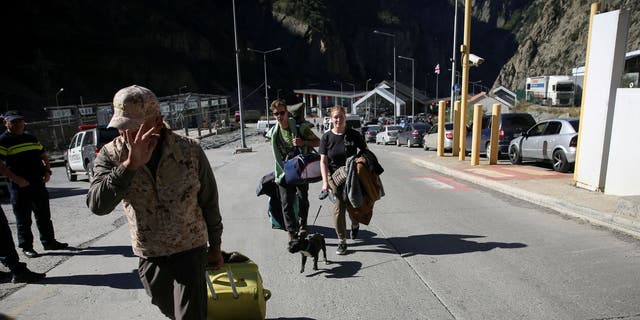 Travelers from Russia cross the border to Georgia at the Zemo Larsi/Verkhny Lars station, Georgia September 26, 2022. 