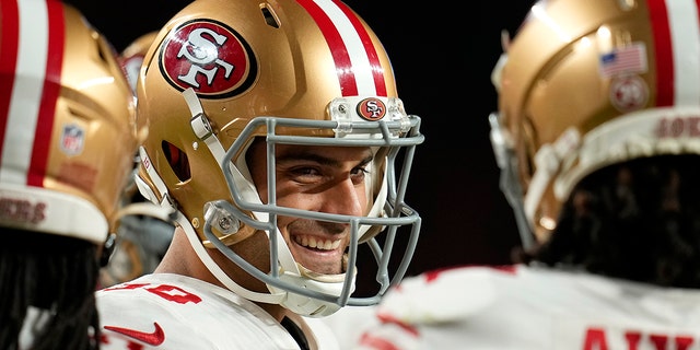 San Francisco 49ers quarterback Jimmy Garoppolo smiles in the huddle during the first half of a game against the Denver Broncos in Denver, Sunday, Sept. 25, 2022.