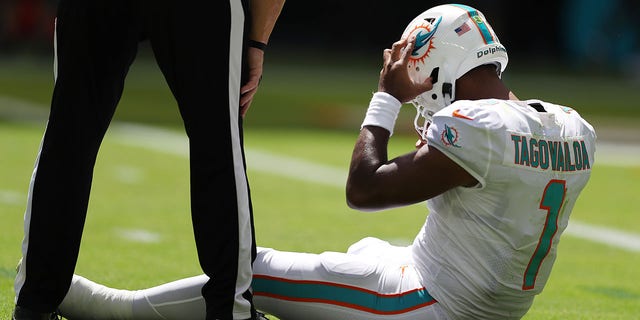 Quarterback Tua Tagovailoa of the Miami Dolphins sits on the turf during the first half of a game against the Buffalo Bills at Hard Rock Stadium Sept. 25, 2022, in Miami Gardens, Fla. 