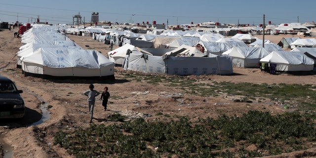 Boys walk at al-Hol displacement camp in Hasaka governorate, Syria, March 8, 2019. 