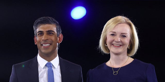 Conservative leadership candidates Liz Truss and Rishi Sunak stand together as they attend a hustings event, part of the Conservative Party leadership campaign, in London Aug. 31, 2022. 