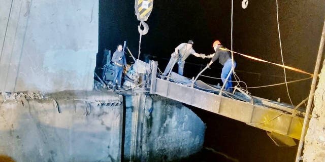 Workers repair a hydraulic structure damaged by a Russian missile strike, amid Russia's attack on Ukraine, in Kryvyi Rih, Ukraine, in this handout picture released Sept. 15, 2022. 