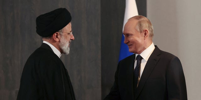 Russian President Vladimir Putin, right, shakes hands with Iranian President Ebrahim Raisi during a meeting on the sidelines of the Shanghai Cooperation Organization (SCO) summit in Samarkand, Uzbekistan, on Thursday. 