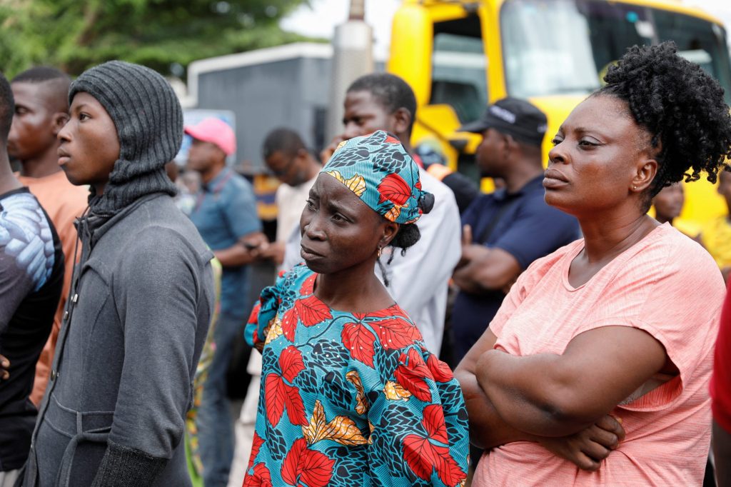 People watch rescue operations after an under-construction building collapsed in Lagos.