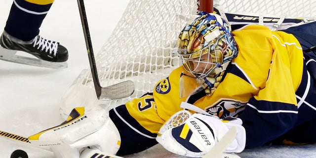 Nashville Predators goalie Pekka Rinne, of Finland, blocks a shot against the New York Islanders in the first period of an NHL hockey game on Saturday, Oct. 12, 2013, in Nashville, Tenn. (AP Photo/Mark Humphrey)