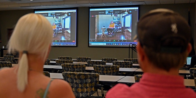 Members of the public watch testimony during the zoom broadcast of the Michael Carneal parole hearing at the West Kentucky Community and Technical College in Paducah, Ky., Monday, Sept. 19, 2022. 