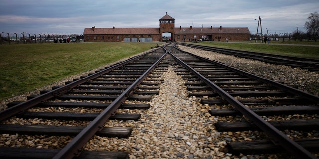 FILE - In this Saturday, Dec. 7, 2019 photo the railway tracks where hundreds of thousands of people arrived to be directed to the gas chambers inside the former Nazi death camp of Auschwitz Birkenau, or Auschwitz II, are pictured in Oswiecim, Poland.