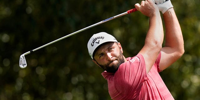 Jon Rahm hits from the fairway on the third hole during the final round of play in the Tour Championship golf tournament at East Lake Golf Club, Sunday, Sept. 5, 2021, in Atlanta. 