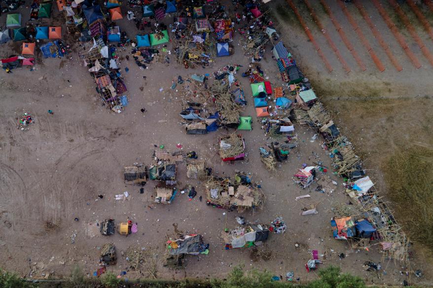 An area where about 14,000 migrants, many from Haiti, were camping out along the Del Rio International Bridge is seen with a large portion of the area cleaned up as authorities continue to process and remove them, Thursday, Sept. 23, 2021, in Del Rio, Texas.