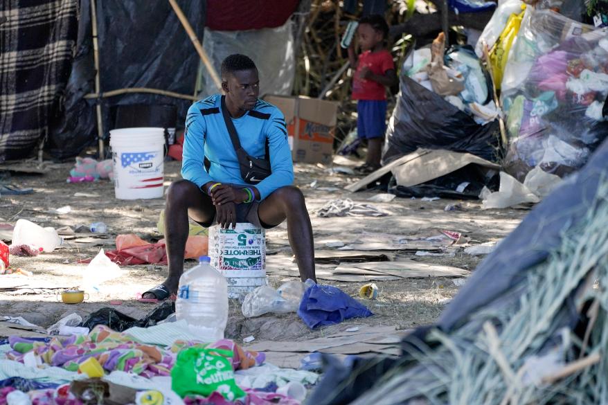 a migrant man is seen in an encampment under the Del Rio International Bridge where migrants, many from Haiti, have been staying after crossing the Rio Grande, in Del Rio, Texas.