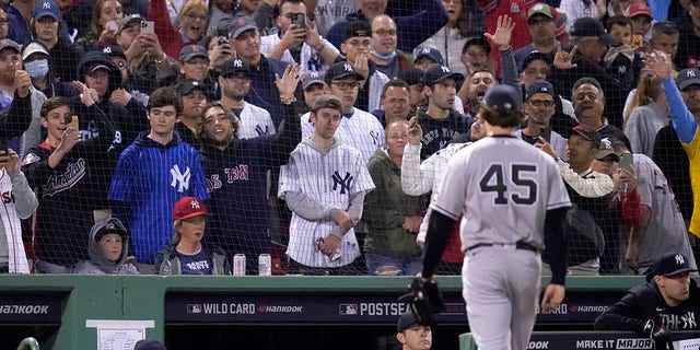 Fans react as New York Yankees starting pitcher Gerrit Cole (45) is taken out in the third inning of an American League Wild Card playoff baseball game against the Boston Red Sox at Fenway Park, Tuesday, Oct. 5, 2021, in Boston.