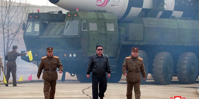 FILE - In this photo distributed by the North Korean government, North Korean leader Kim Jong Un, center, walks around what it says is a Hwasong-17 intercontinental ballistic missile (ICBM) on the launcher, at an undisclosed location in North Korea on March 24, 2022. 