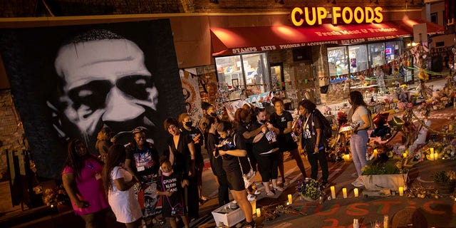 FILE - The family of Daunte Wright gathers on the one-year anniversary of George Floyd's death, May 25, 2021, in Minneapolis. A candlelight vigil to honor Floyd's memory at the intersection where he died was among the remembrances scheduled for Wednesday's second anniversary of the Black man's killing at the hands of Minneapolis police officers.