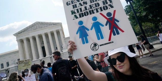 Faith Adams from Bangor, Maine, protests about abortion, Friday, June 24, 2022, outside the Supreme Court in Washington.