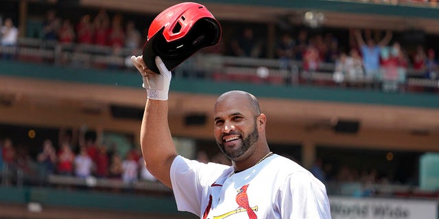 The St. Louis Cardinals' Albert Pujols tips his cap after hitting a grand slam during the third inning of a game against the Colorado Rockies Aug. 18, 2022, in St. Louis. 