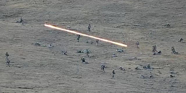 Azerbaijanian servicemen cross the Armenian-Azerbaijani border and approaching the Armenian positions, Tuesday, Sept. 13, 2022.