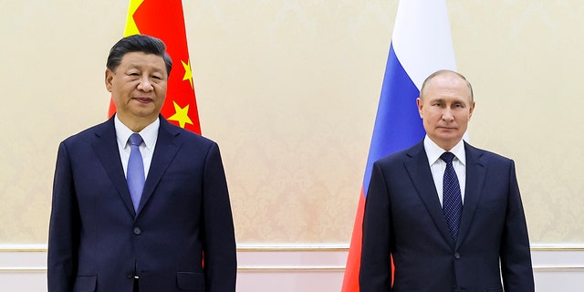 Chinese President Xi Jinping, left, and Russian President Vladimir Putin pose for a photo on the sidelines of the Shanghai Cooperation Organization (SCO) summit in Samarkand, Uzbekistan, Thursday, Sept. 15, 2022. 