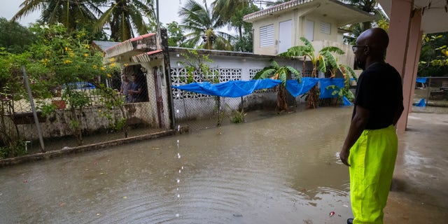 A worker of the Loiza municipality calls on residents to evacuate due to imminent flooding due to the rains of Hurricane Fiona, in Loiza, Puerto Rico, Sunday, September 18, 2022.