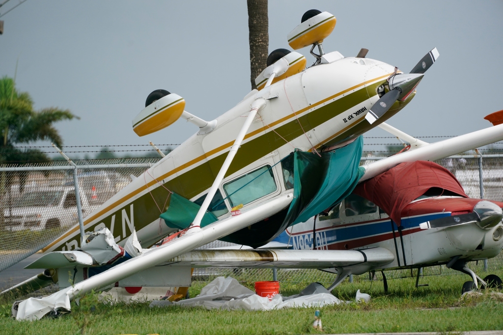 Strong winds caused damage to cars, powerlines, homes, and planes.