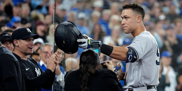 New York Yankees' Aaron Judge celebrates his 61st home run of the season, a two-run shot against the Toronto Blue Jays, and acknowledges his family during seventh inning of a baseball game Wednesday, Sept. 28, 2022, in Toronto. 