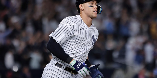 New York Yankees' Aaron Judge runs toward first after hitting his 60th home run of the season, during the ninth inning of the team's baseball game against the Pittsburgh Pirates on Tuesday, Sept. 20, 2022, in New York. 