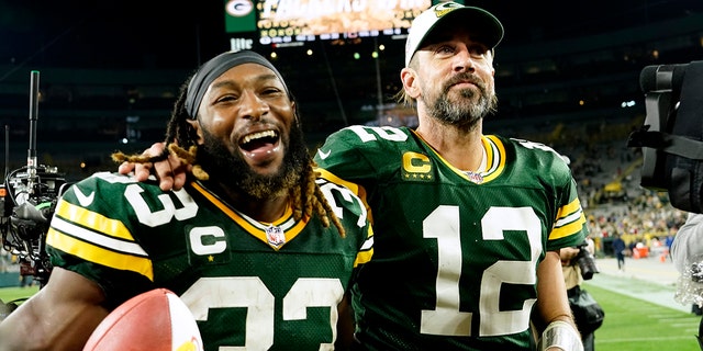 Green Bay Packers running back Aaron Jones, #33, walks off the field with teammate quarterback Aaron Rodgers, #12, after an NFL football game against the Chicago Bears Sunday, Sept. 18, 2022, in Green Bay, Wisconsin. 