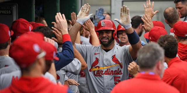 Albert Pujols #5 of the St. Louis Cardinals celebrates with teammates in the dugout after hitting a two-run home run in the ninth inning during the game against the Pittsburgh Pirates at PNC Park on Sept. 11, 2022 in Pittsburgh, Pennsylvania.