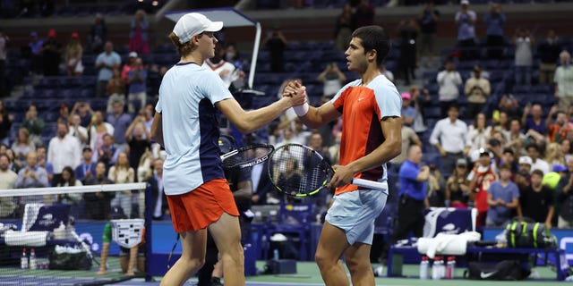 Carlos Alcaraz of Spain, right, celebrates match point against Jannik Sinner of Italy during their Men’s Singles Quarterfinal match at the US Open in NYC.