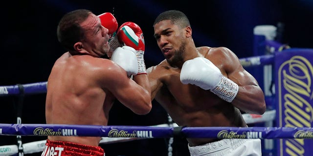 World Heavyweight boxing champion Britain's Anthony Joshua lands a blow on challenger Bulgaria's Kubrat Pulev during their Heavyweight title fight at Wembley Arena in London Saturday, Dec. 12, 2020. 