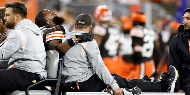 Cleveland Browns linebacker Anthony Walker Jr. (5) is taken off the field after being injured during the second half of an NFL football game against the Pittsburgh Steelers in Cleveland, Thursday, Sept. 22, 2022.