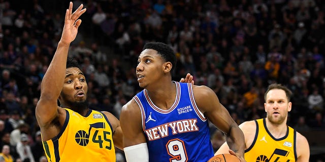 Donovan Mitchell #45 of the Utah Jazz defends RJ Barrett #9 of the New York Knicks during the second half of a game at Vivint Smart Home Arena on February 07, 2022 in Salt Lake City, Utah.