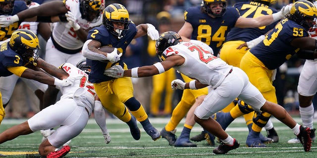 Michigan running back Blake Corum (2) makes a move on Maryland defensive back Beau Brade (25) in the first half of a game in Ann Arbor, Mich., Saturday, Sept. 24, 2022.