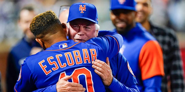 New York Mets manager Buck Showalter, right, hugs New York Mets' Eduardo Escobar after a baseball game against the Miami Marlins Wednesday, Sept. 28, 2022, in New York. The Mets won 5-4.