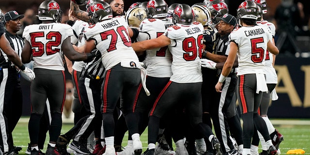 Officials break up a brawl between the New Orleans Saints and the Tampa Bay Buccaneers during the second half in New Orleans on Sept. 18, 2022.