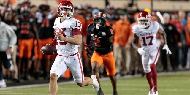 Oklahoma Sooners quarterback Caleb Williams, #13, runs the ball up field against the Oklahoma State Cowboys on Nov. 27, 2021 at Boone Pickens Stadium in Stillwater, Oklahoma.