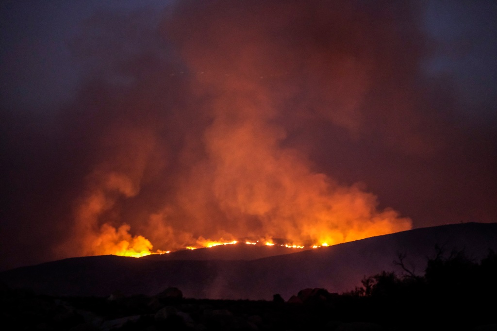 Smoke rises from a wildfire burning on a hillside Tuesday, Sept. 6, 2022, near Hemet, Calif. 