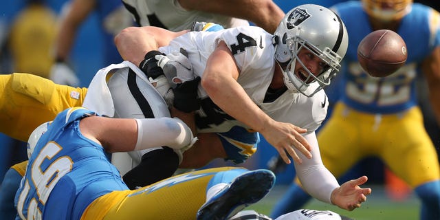 Quarterback Derek Carr #4 of the Las Vegas Raiders fumbles the ball during the fourth quarter against the Los Angeles Chargers at SoFi Stadium on September 11, 2022 in Inglewood, California.