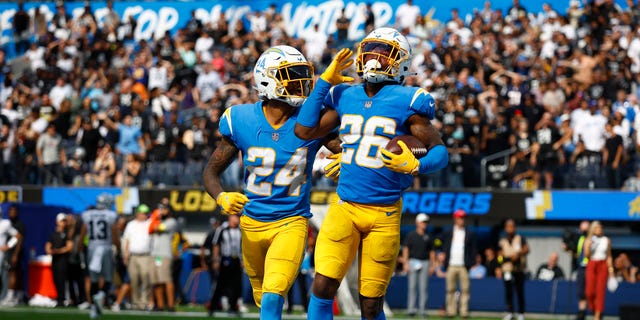 Safety Nasir Adderley #24 of the Los Angeles Chargers and cornerback Asante Samuel Jr. #26 of the Los Angeles Chargers celebrate after Samuel's interception during the fourth quarter against the Las Vegas Raiders at SoFi Stadium on September 11, 2022 in Inglewood, California.