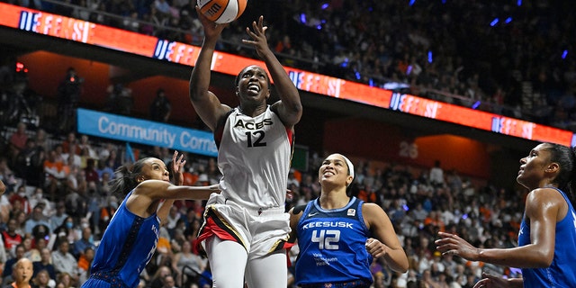 Las Vegas Aces' Chelsea Gray (12) goes up for a basket against the Connecticut Sun during Game 4 of the WNBA Finals in Uncasville, Connecticut, on Sept. 18, 2022.