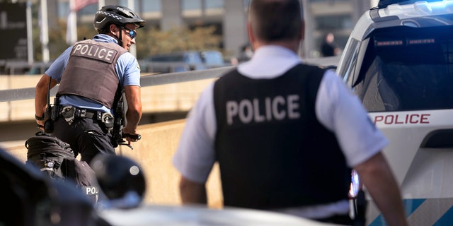 Chicago police officers work at the scene of a shooting at 63rd St. and Bell Avenue in Chicago.