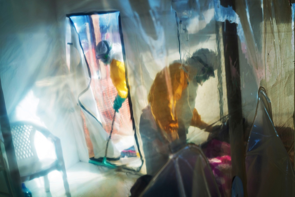 Health workers wearing protective suits tend to to an Ebola victim kept in an isolation tent in Beni, Democratic Republic of Congo in 2019.