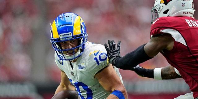 Los Angeles Rams wide receiver Cooper Kupp (10) makes a catch against Arizona Cardinals safety Budda Baker (3) during the first half of an NFL football game, Sunday, Sept. 25, 2022, in Glendale, Ariz. 