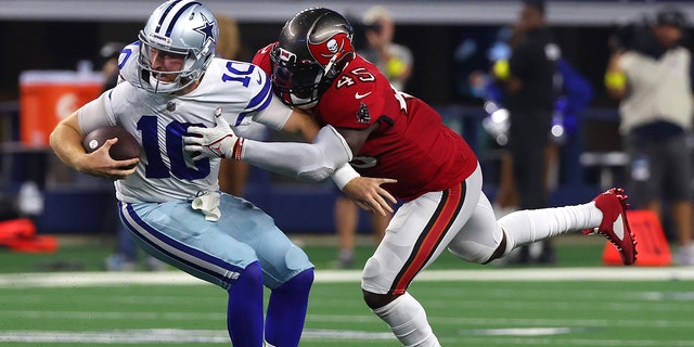 Devin White, #45 of the Tampa Bay Buccaneers, tackles Cooper Rush, #10 of the Dallas Cowboys, during the second half at AT&amp; Stadium on Sept. 11, 2022 in Arlington, Texas. 