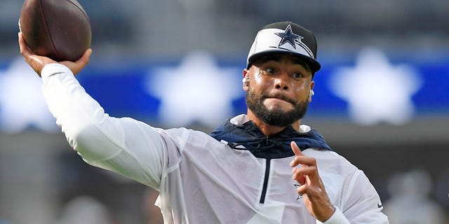 Quarterback Dak Prescott of the Dallas Cowboys warms up before a preseason game against the Los Angeles Chargers at SoFi Stadium in Inglewood, California, on Aug. 20, 2022.